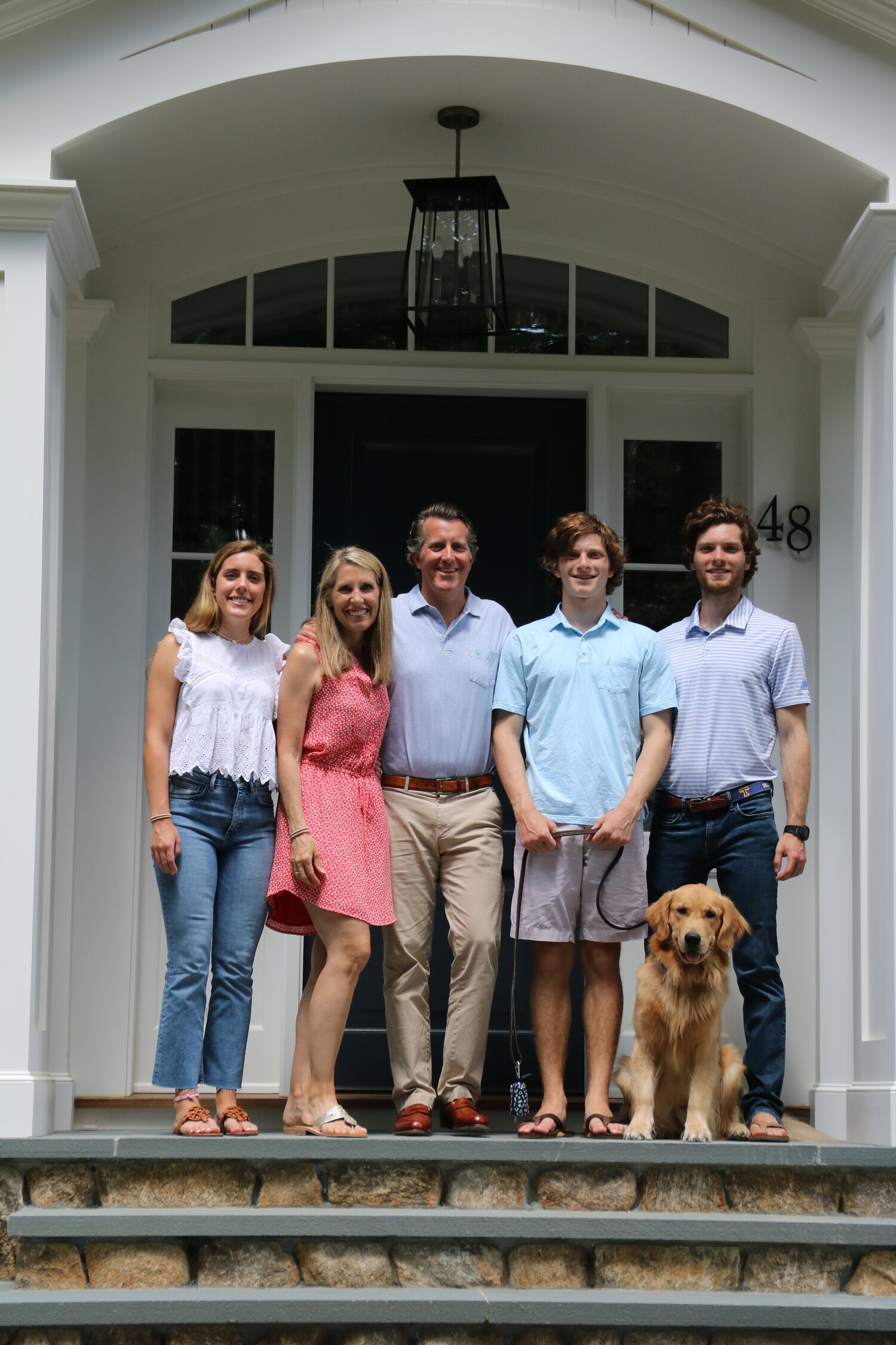 Image of family standing on front porch